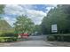 Community entrance with signage, lush landscaping, and easy access to the neighborhood at 955 Tributary Way, Dacula, GA 30019