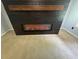Modern fireplace showing orange flames, with stained wood mantle, and black plank wall at 955 Tributary Way, Dacula, GA 30019