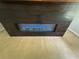 Close up of the modern electric fireplace, with illuminated blue flames at 955 Tributary Way, Dacula, GA 30019