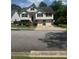 Charming two-story home featuring a two-car garage, landscaped yard, and inviting front entrance at 955 Tributary Way, Dacula, GA 30019