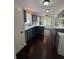Bright kitchen features blue cabinets, stainless appliances, and hardwood flooring at 955 Tributary Way, Dacula, GA 30019