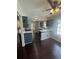 Open kitchen boasts blue cabinets, a ceiling fan, and hardwood flooring at 955 Tributary Way, Dacula, GA 30019