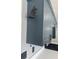 Close up of kitchen blue cabinetry and stainless appliances with black hardware at 955 Tributary Way, Dacula, GA 30019