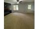 Carpeted living room with a black electric fireplace feature wall at 955 Tributary Way, Dacula, GA 30019