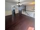Spacious living room with hardwood floors flowing into the foyer and kitchen at 955 Tributary Way, Dacula, GA 30019