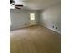 Living room with neutral carpet, ceiling fan, and door to the outside at 955 Tributary Way, Dacula, GA 30019