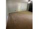 Spacious living room features neutral walls, carpet, ceiling fan and a black fireplace feature wall at 955 Tributary Way, Dacula, GA 30019