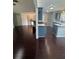 Open living space with hardwood floors seamlessly flowing into the kitchen at 955 Tributary Way, Dacula, GA 30019