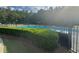 Community pool area with lush green bushes and dark metal fence at 955 Tributary Way, Dacula, GA 30019