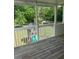 Enclosed porch with wood flooring overlooks a backyard playset at 955 Tributary Way, Dacula, GA 30019