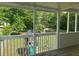 Enclosed porch with wood flooring overlooks a green backyard playset at 955 Tributary Way, Dacula, GA 30019