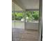 Screened porch with wooden flooring and white railing at 955 Tributary Way, Dacula, GA 30019
