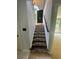 Staircase leading to the front door with a decorative number sign and sidelight window at 955 Tributary Way, Dacula, GA 30019
