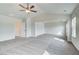 Large bedroom area featuring neutral paint, plush carpet and a ceiling fan for added comfort at 203 Arabella Pkwy, Locust Grove, GA 30248