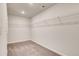 Walk-in closet features carpet flooring and extensive wire shelving for organization at 203 Arabella Pkwy, Locust Grove, GA 30248