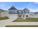 Charming two-story home with a two-car garage, stone accents, and lush green lawn at 203 Arabella Pkwy, Locust Grove, GA 30248
