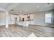 Modern kitchen with white cabinets, a large island with pendant lighting, and hardwood floors at 203 Arabella Pkwy, Locust Grove, GA 30248