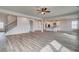 Bright, open-concept living space featuring hardwood floors and modern kitchen with stainless steel appliances at 203 Arabella Pkwy, Locust Grove, GA 30248