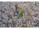 Aerial view showcases this home surrounded by a canopy of trees, highlighting the privacy of this residence at 4220 Chapel Hill Farms Dr, Douglasville, GA 30135
