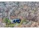 Aerial view of house with an expansive driveway, set amidst an abundant forest backdrop at 4220 Chapel Hill Farms Dr, Douglasville, GA 30135