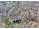 Aerial view of the house surrounded by a forest and a winding driveway at 4220 Chapel Hill Farms Dr, Douglasville, GA 30135