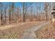 Backyard featuring mature trees and a gentle slope at 4220 Chapel Hill Farms Dr, Douglasville, GA 30135