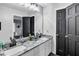 Bathroom featuring double sinks with modern faucets and a large mirror at 4220 Chapel Hill Farms Dr, Douglasville, GA 30135