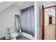Bathroom features a toilet, mirror, and shower with a gray patterned curtain at 4220 Chapel Hill Farms Dr, Douglasville, GA 30135