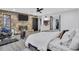 Large bedroom with hardwood floors, a stone fireplace, and a ceiling fan at 4220 Chapel Hill Farms Dr, Douglasville, GA 30135