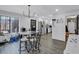 Dining area open to kitchen, featuring modern light fixture and light gray flooring at 4220 Chapel Hill Farms Dr, Douglasville, GA 30135