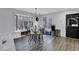Dining area with bay window, modern light fixture, and light gray flooring at 4220 Chapel Hill Farms Dr, Douglasville, GA 30135