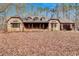 Stone home featuring a covered front porch and gabled roof in a private setting at 4220 Chapel Hill Farms Dr, Douglasville, GA 30135