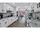 Bright kitchen features white cabinets, granite counters, stainless appliances, and wood floors at 4220 Chapel Hill Farms Dr, Douglasville, GA 30135