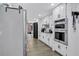 Kitchen with stainless steel double ovens, white cabinets, and light gray flooring at 4220 Chapel Hill Farms Dr, Douglasville, GA 30135