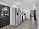 Kitchen with stainless steel appliances, white cabinets, and light gray flooring at 4220 Chapel Hill Farms Dr, Douglasville, GA 30135