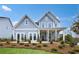 Charming two-story home with board and batten siding, inviting front porch, and professionally landscaped yard at 5230 Hyde Rd, Cumming, GA 30040