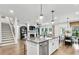 Modern kitchen with an island, stainless steel appliances, and eat-in dining area at 5230 Hyde Rd, Cumming, GA 30040