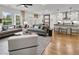 Open-concept living room and kitchen with hardwood floors, modern lighting, and stylish furnishings at 5230 Hyde Rd, Cumming, GA 30040