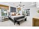 Bright primary bedroom with large windows, sitting area, and neutral colors creating a peaceful space at 5230 Hyde Rd, Cumming, GA 30040