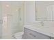 Bright bathroom showcases a shower with glass door and a sink with gray vanity and white countertops at 4356 N Buckhead Ne Dr, Atlanta, GA 30342