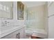 Modern bathroom with a shower and tub combination, white cabinets, and tile walls at 4356 N Buckhead Ne Dr, Atlanta, GA 30342