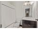 Cozy bathroom with a shower featuring a white curtain and a vanity with dark cabinets at 4356 N Buckhead Ne Dr, Atlanta, GA 30342