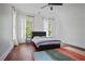 Spacious bedroom with wood floors, two windows, and modern furnishings at 4356 N Buckhead Ne Dr, Atlanta, GA 30342