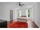 Bright bedroom features hardwood floors, white walls, ceiling fan, and natural light from two windows at 4356 N Buckhead Ne Dr, Atlanta, GA 30342