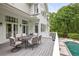 Large wooden deck with table and chairs overlooks the lovely in-ground pool at 4356 N Buckhead Ne Dr, Atlanta, GA 30342