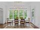 Inviting dining room featuring a modern chandelier and large windows overlooking the lush greenery at 4356 N Buckhead Ne Dr, Atlanta, GA 30342