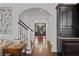 Elegant foyer showcasing hardwood floors, staircase, and an arched doorway, inviting guests into the home at 4356 N Buckhead Ne Dr, Atlanta, GA 30342