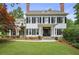 Stately two-story home with a manicured lawn and traditional architectural details like shutters and dormer window at 4356 N Buckhead Ne Dr, Atlanta, GA 30342