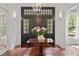 Front foyer showcasing hardwood floors, natural light, and a decorative table with floral arrangement at 4356 N Buckhead Ne Dr, Atlanta, GA 30342