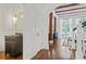 Hallway with hardwood floors, a stylish vanity, and an arched doorway leading to other living areas at 4356 N Buckhead Ne Dr, Atlanta, GA 30342